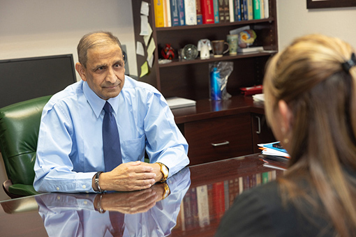 Family Medicine Doctor Talking To Bayonet Point Lady Visiting His Clinic