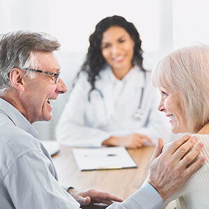 Senior Couple Smiling In Front of Primary Care Physician in Bayonet Point FL